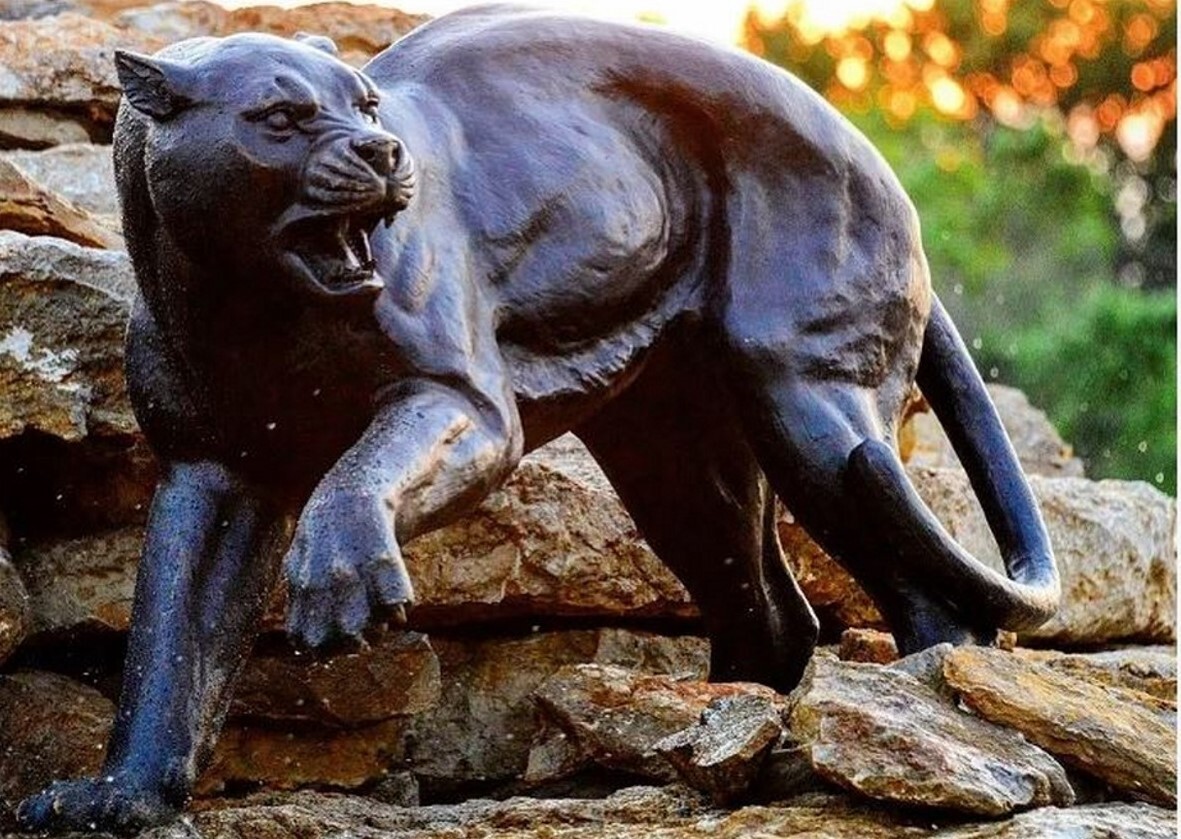 This bronze sculpture set features a beautiful pair of black panthers.