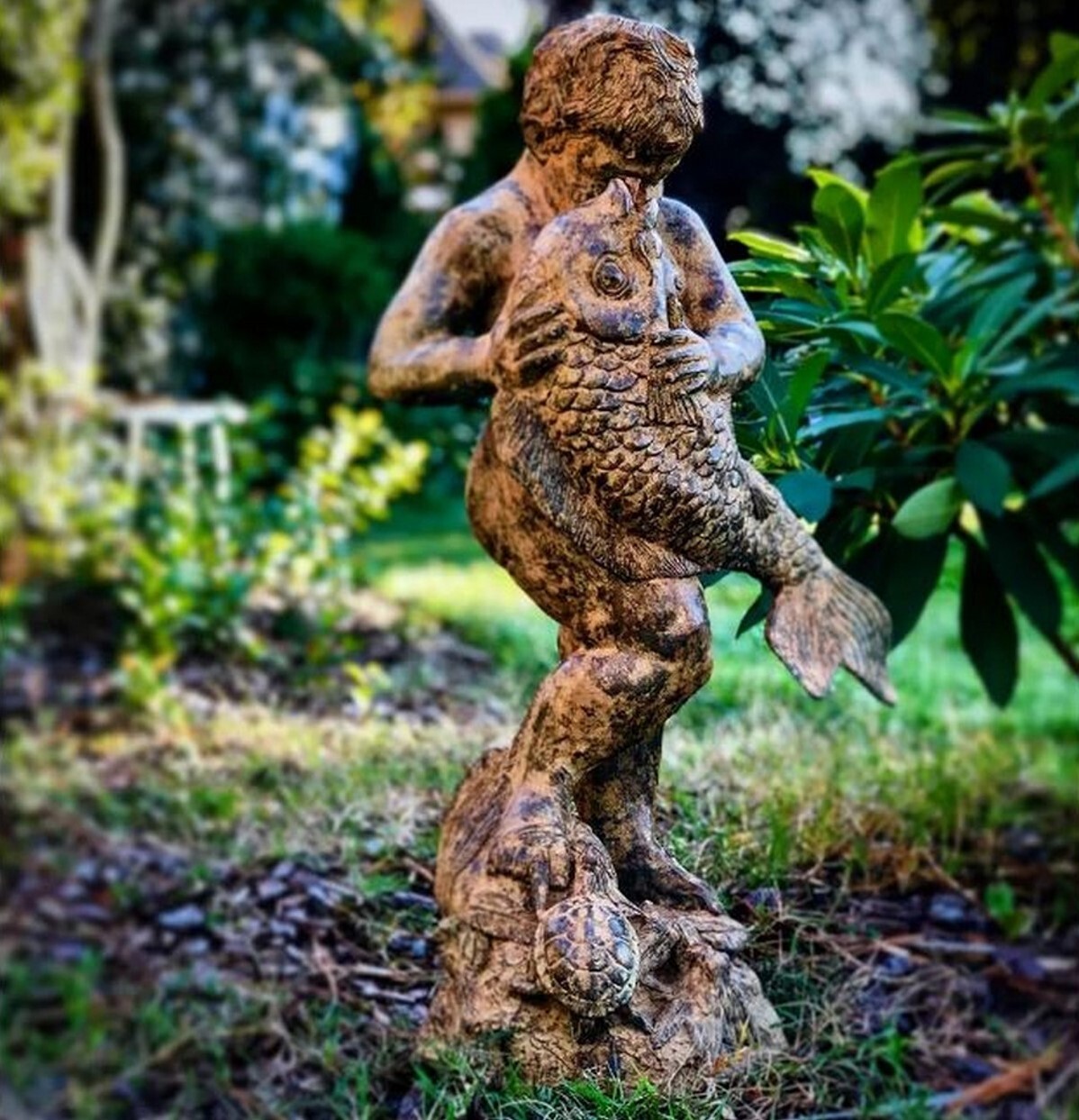 Add a touch of timeless charm to your garden or patio with our exquisite Bronze Boy holding Fish Fountain Sculpture.