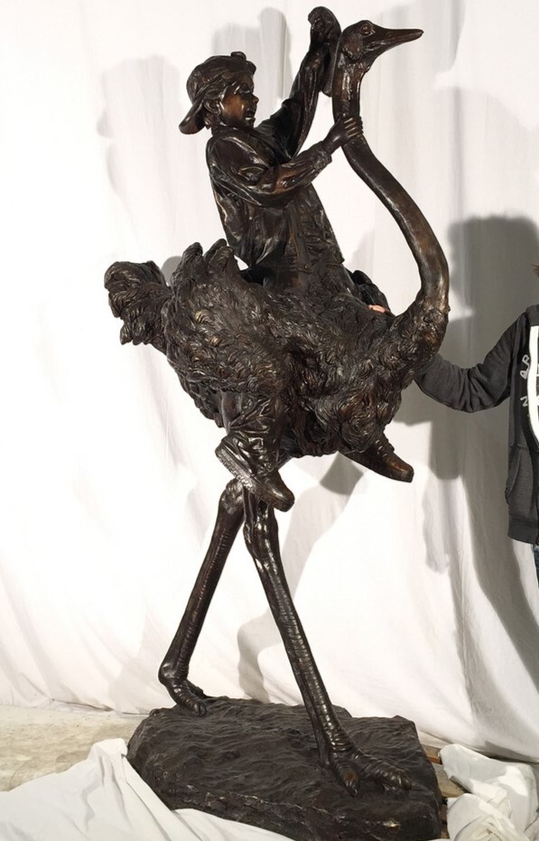 Add a touch of whimsy and adventure to your space with the Bronze Boy on Ostrich Sculpture.
