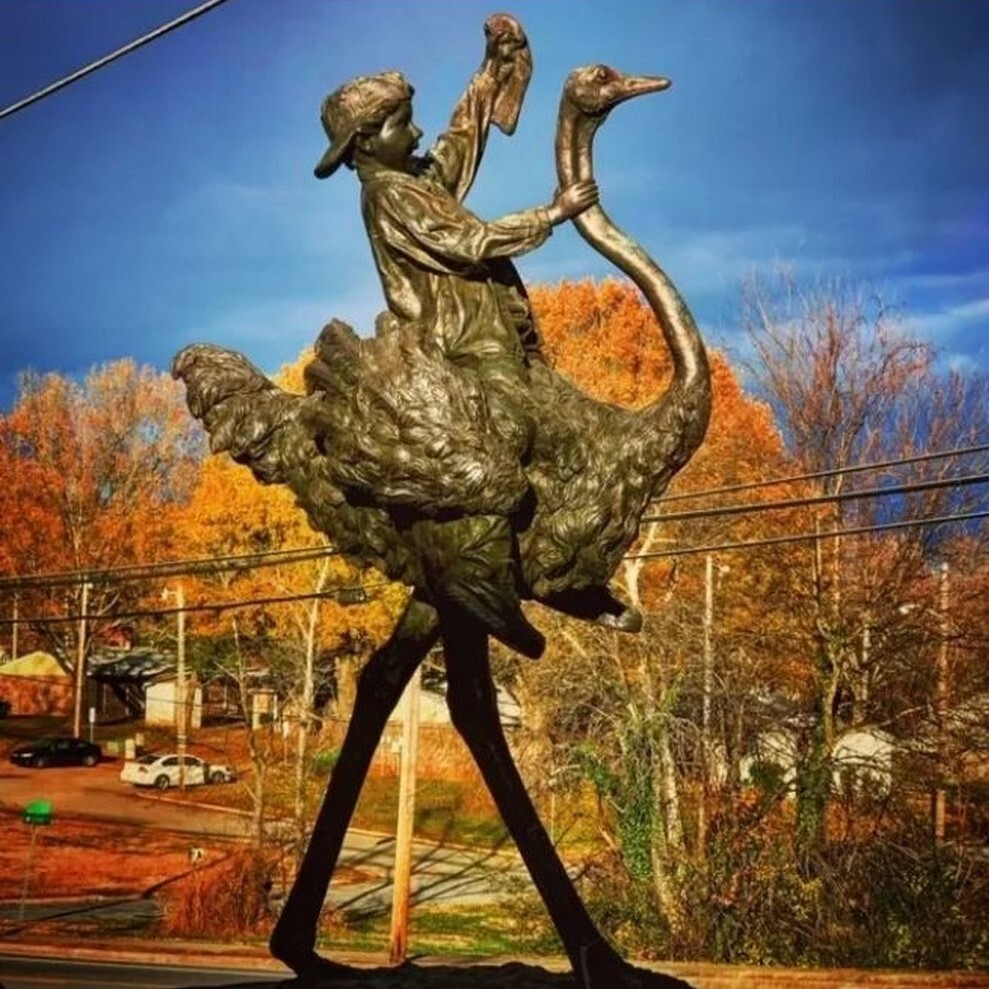 Add a touch of whimsy and adventure to your space with the Bronze Boy on Ostrich Sculpture.
