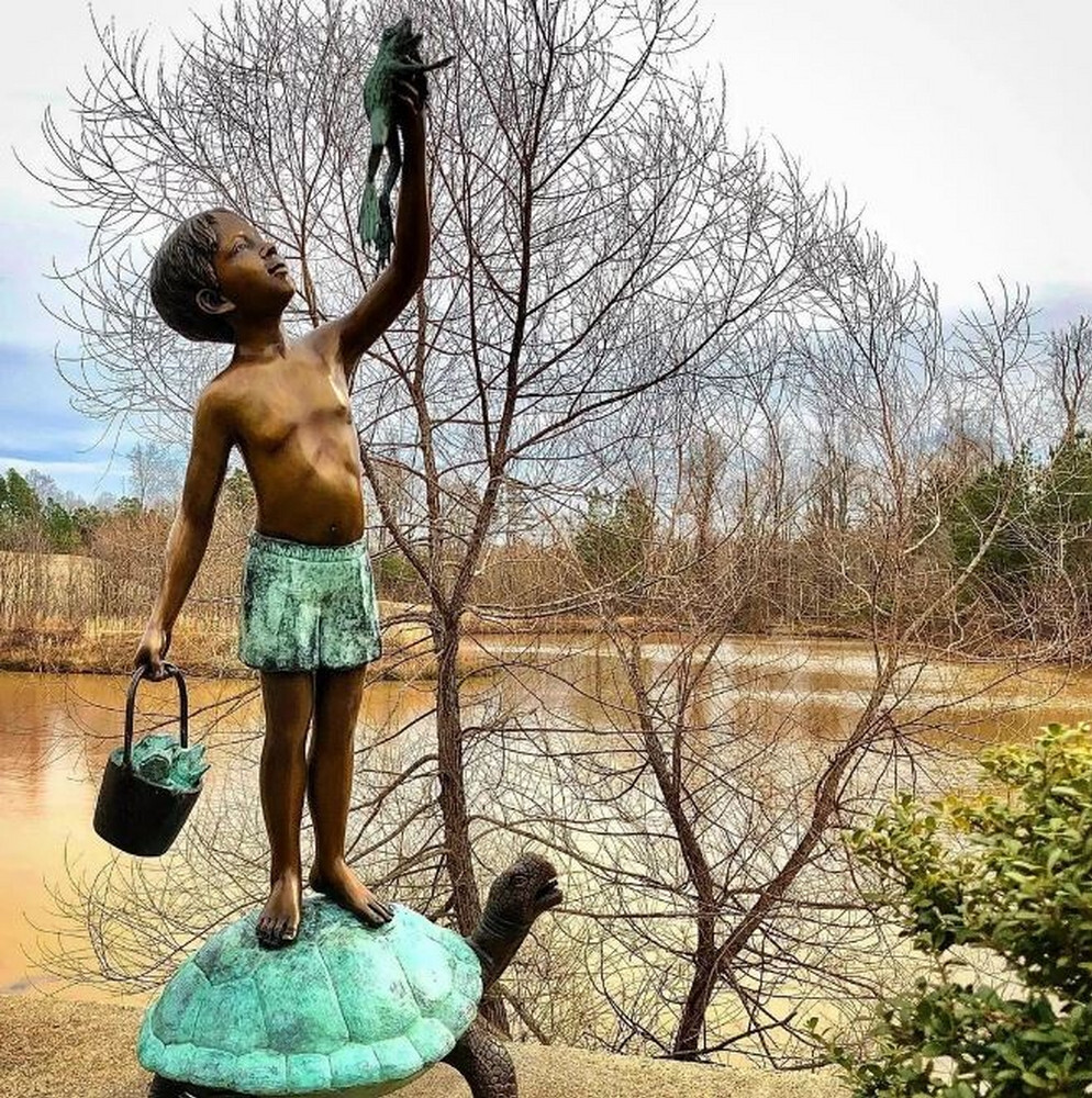 Elevate your garden or home decor with this exquisite Bronze Boy on Turtle Holding Frog Fountain Sculpture. 