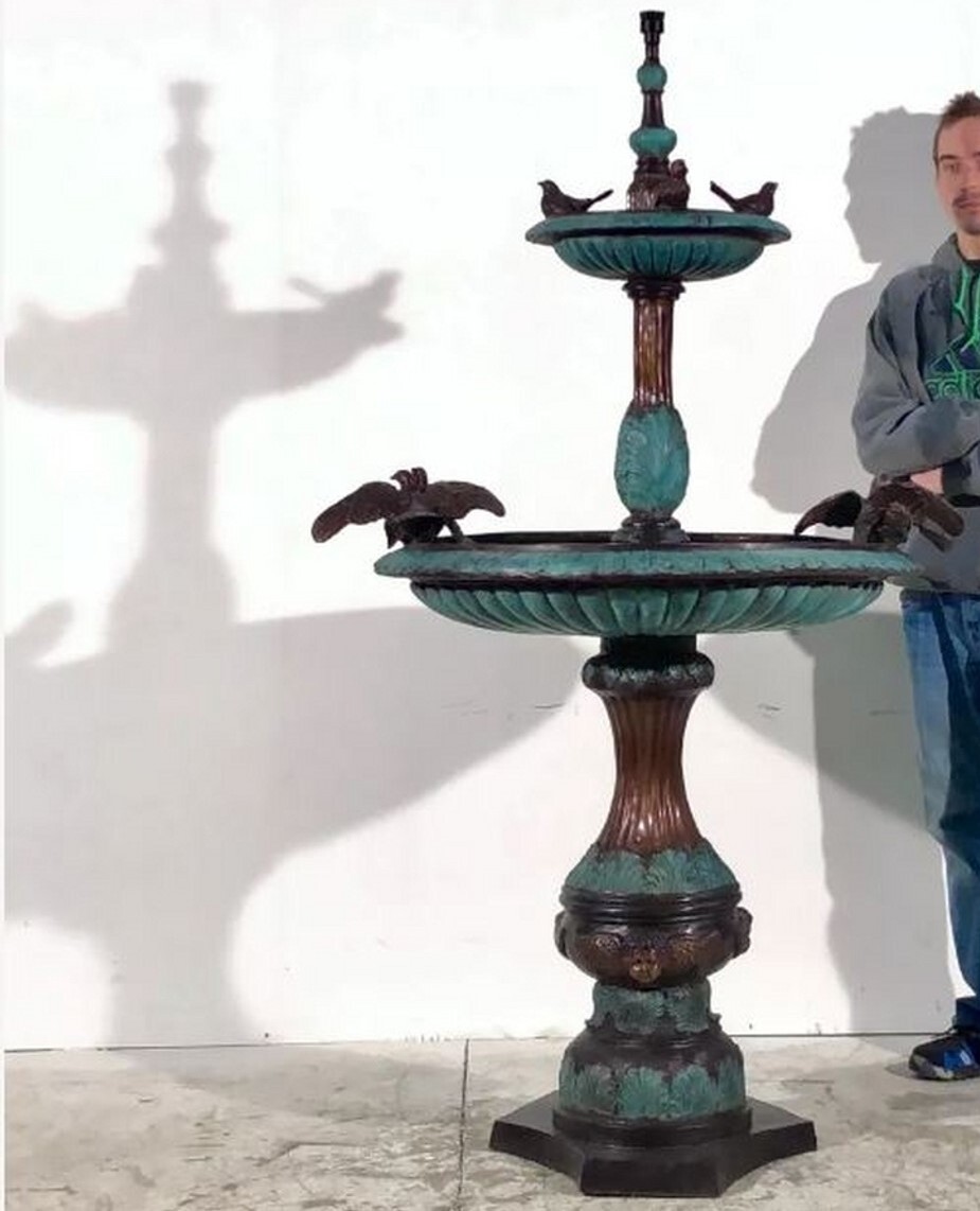 The bronze dove two-tier fountain sculpture features meticulous hand-forged details and a beautiful brown and green fire-applied patina. 