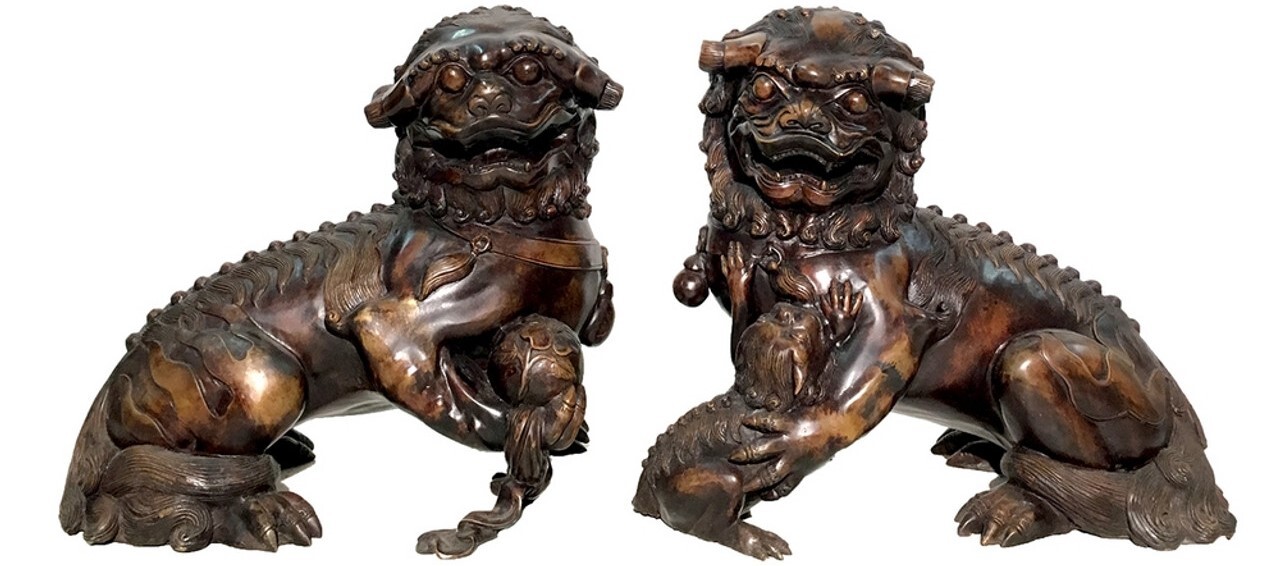 The bronze Foo Dog sculpture pair features a beautiful brown fire-applied patina.