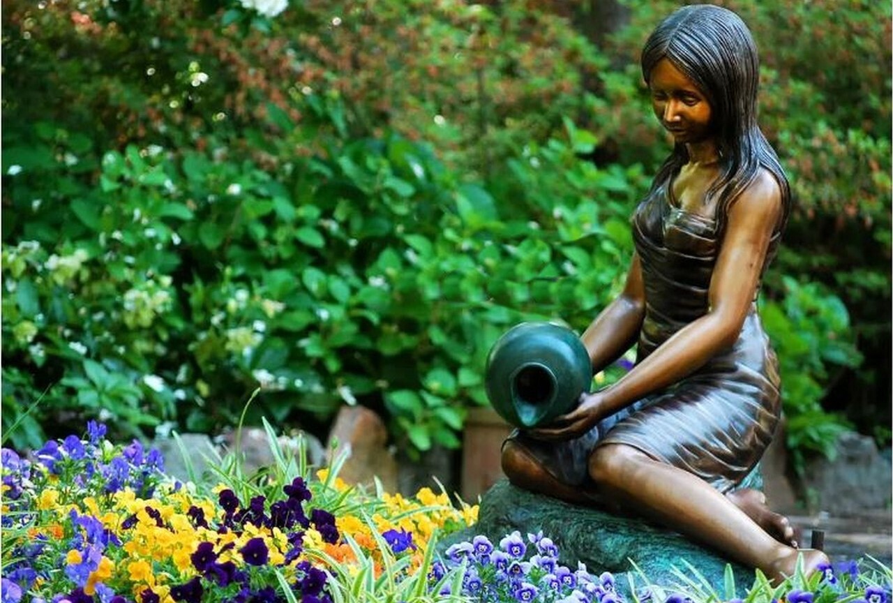 This beautiful life-like sculpture features a self-contained fountain with a girl pouring water from a vase.