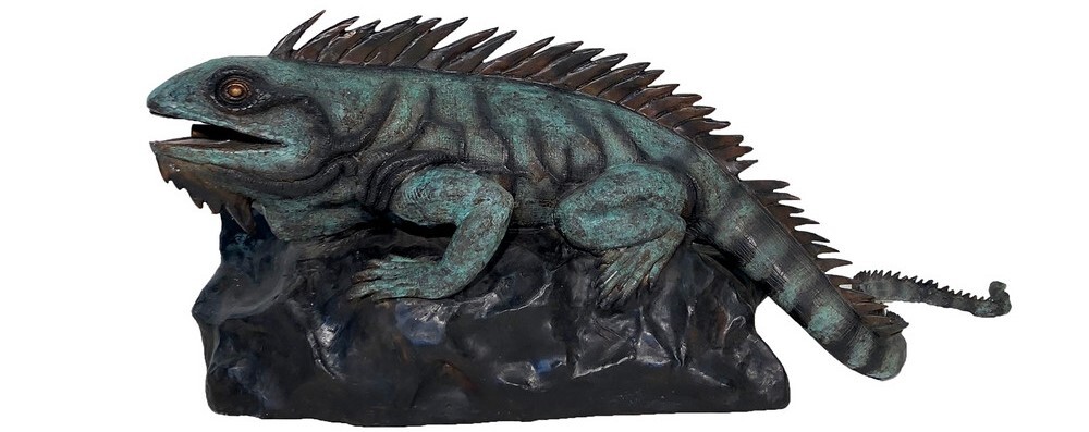 This striking fountain features a lifelike iguana perched confidently atop a rugged rock, releasing a gentle stream of water from its mouth into a surrounding pond or pool. The result is a dynamic fusion of sculpture and water that brings movement, character, and tranquility to any landscape.