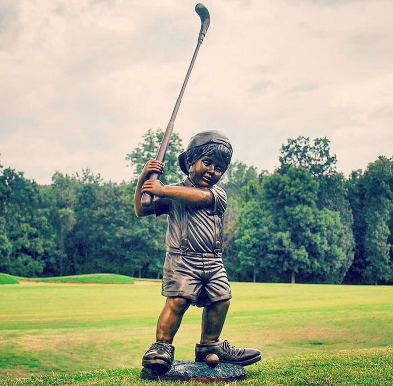 bronze-little-boy-golfer-with-big-shoes-sculpture.jpg