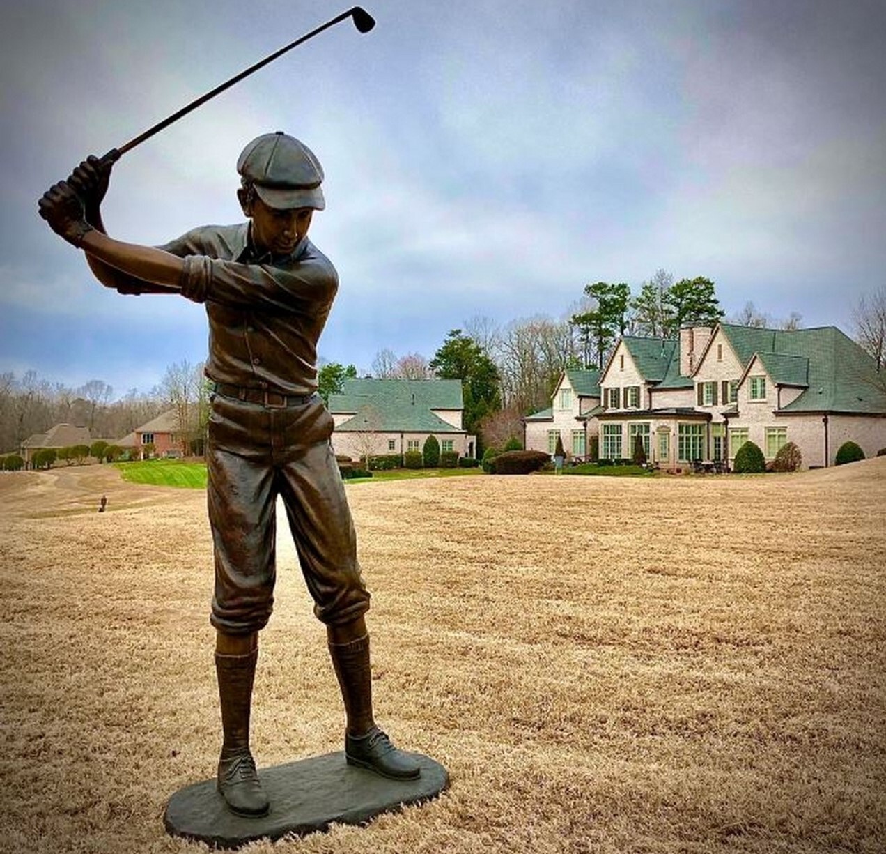 This true-to-life bronze sculpture features a male golfer in mid-swing.