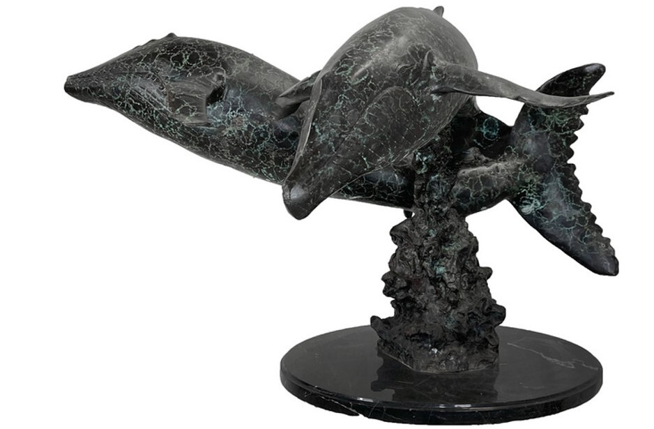 his dynamic bronze tabletop sculpture features two humpback whales leaping among the waves.
