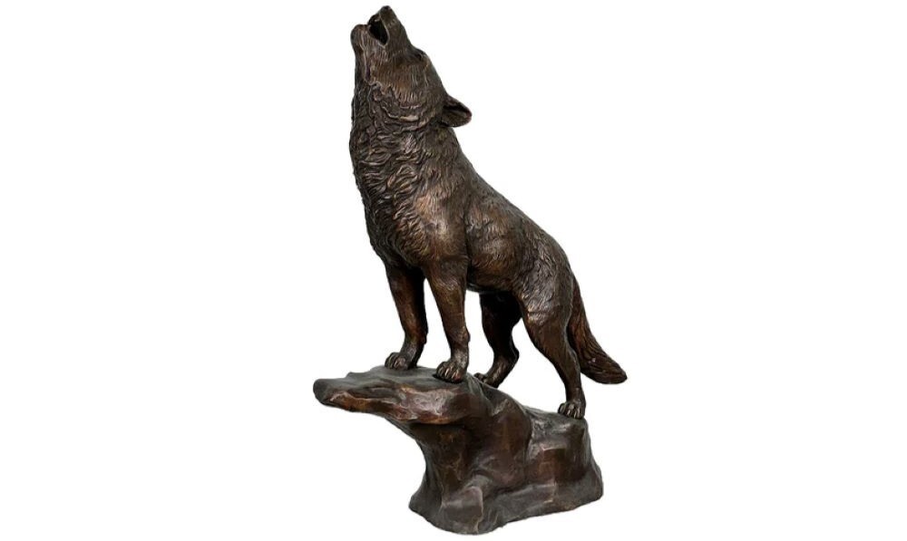 Bring the wild beauty of nature into your home with this stunning Bronze Howling Wolf on Rock Tabletop Sculpture.