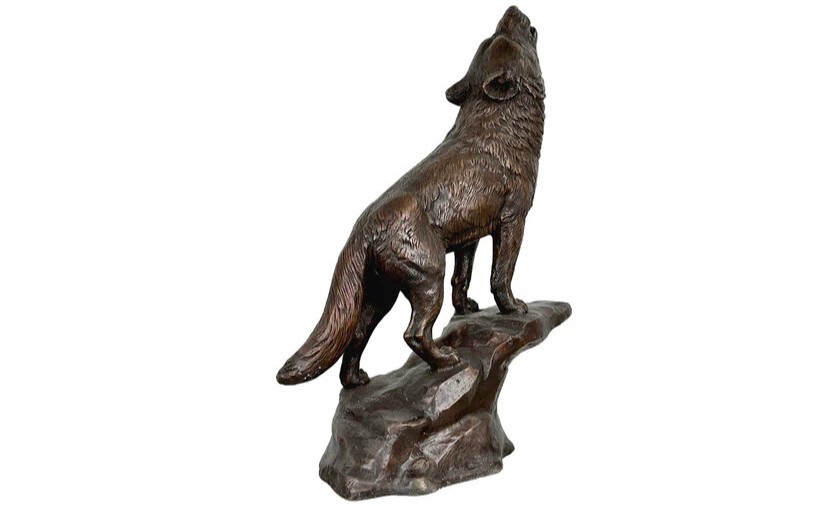 Bring the wild beauty of nature into your home with this stunning Bronze Howling Wolf on Rock Tabletop Sculpture.