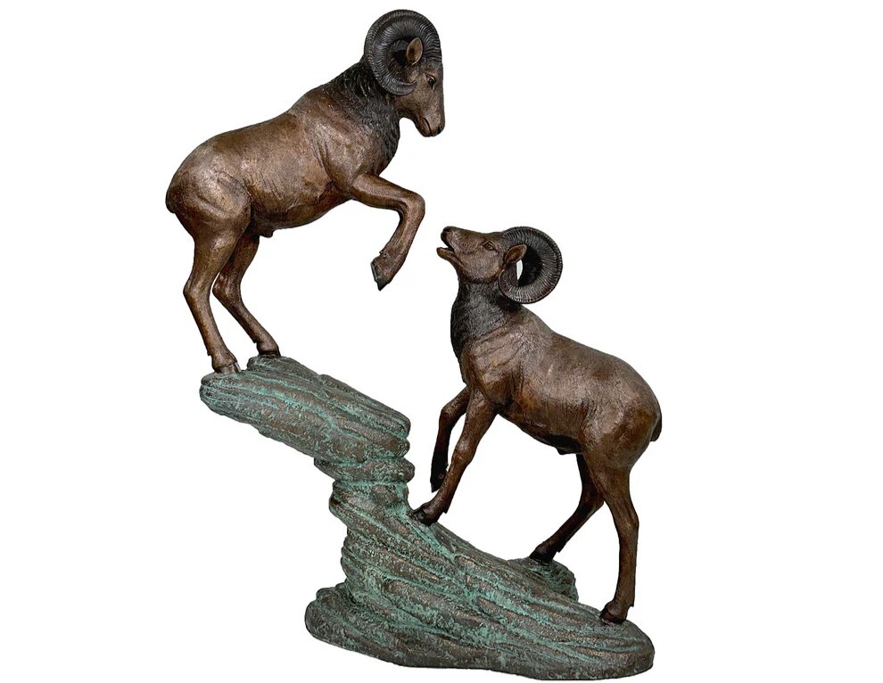 Elevate your decor with the Bronze Two Rams on Rock Sculpture. This stunning piece is cast using the traditional Lost Wax Bronze Casting method, ensuring pristine quality and vivid detail. 
